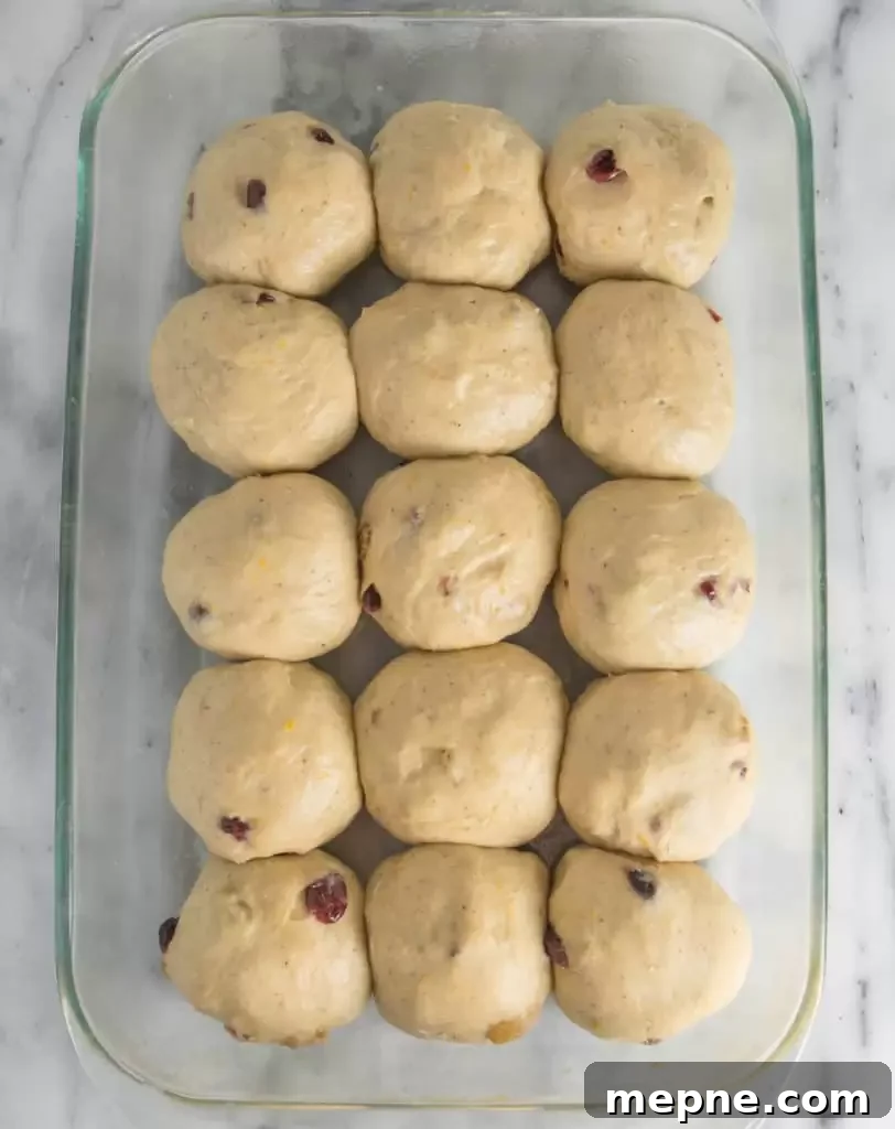 Cranberry Orange Hot Cross Buns Recipe 4 cranberry orange hot cross buns in the baking dish before they go into the oven