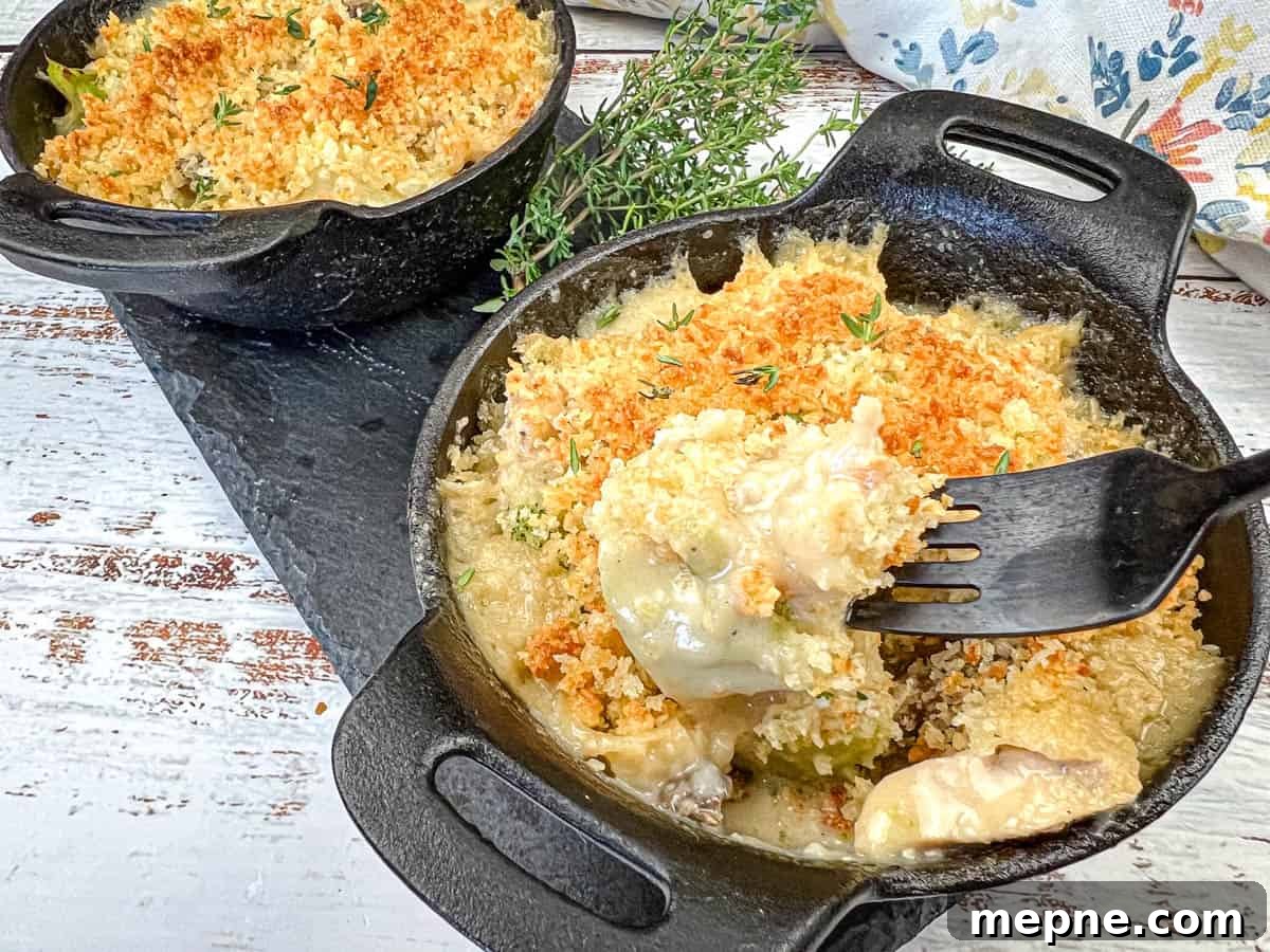 35 Classic Casserole Recipes That Have Everyone Coming Back 12 Two cast-iron skillets filled with vintage chicken divan and a fork dishing up one serving.