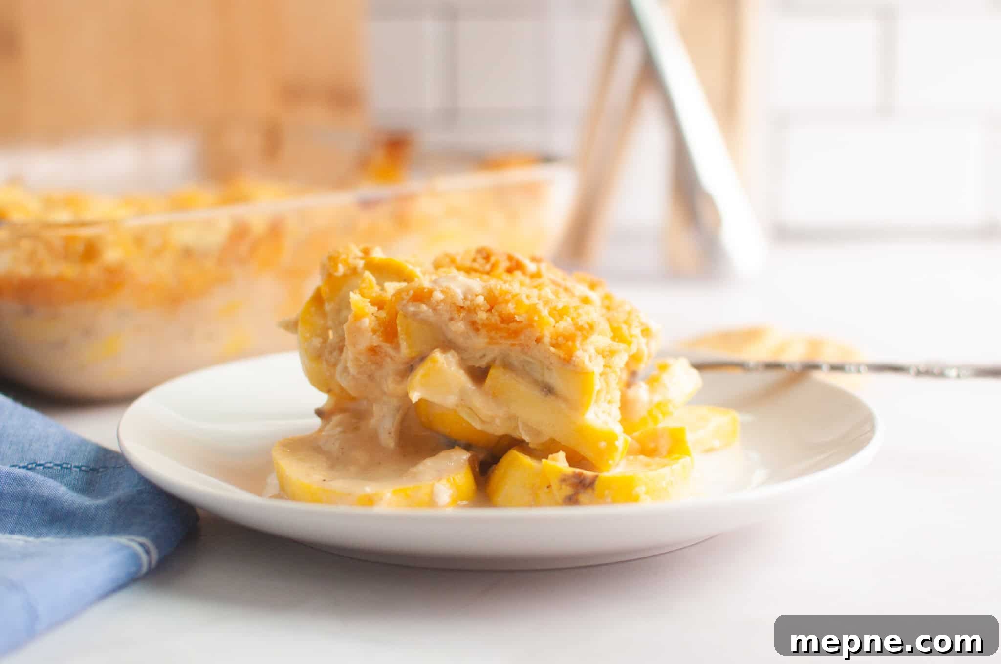 35 Classic Casserole Recipes That Have Everyone Coming Back 17 A serving of squash casserole with a crumb topping is plated on a white dish.