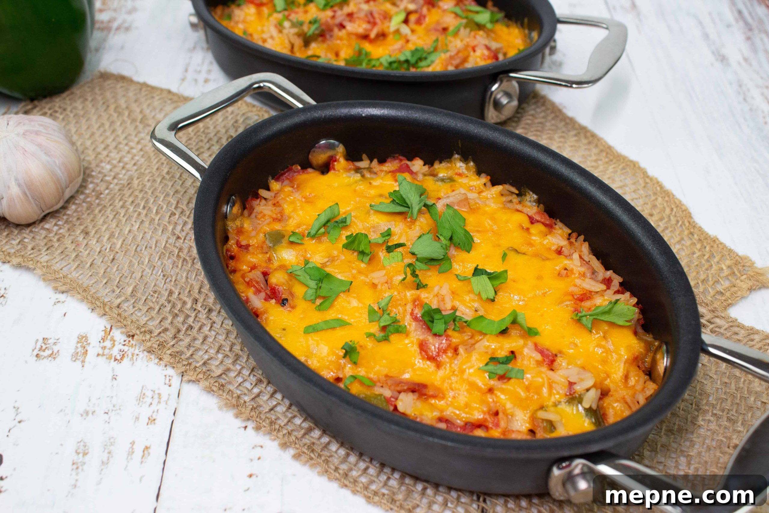 35 Classic Casserole Recipes That Have Everyone Coming Back 26 Baked Spanish Rice in two black baking dishes.