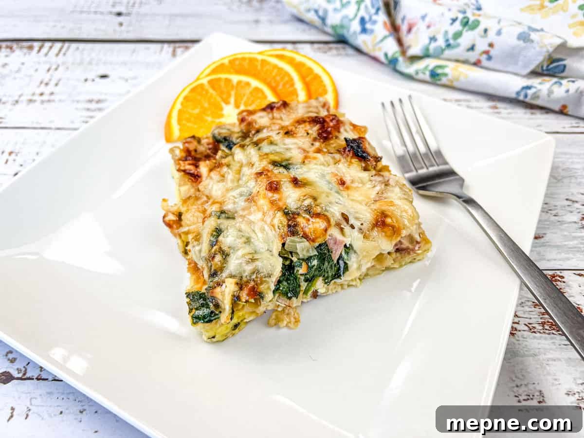 35 Classic Casserole Recipes That Have Everyone Coming Back 36 A white plate with a slice of Croissant breakfast casserole and orange next to it.