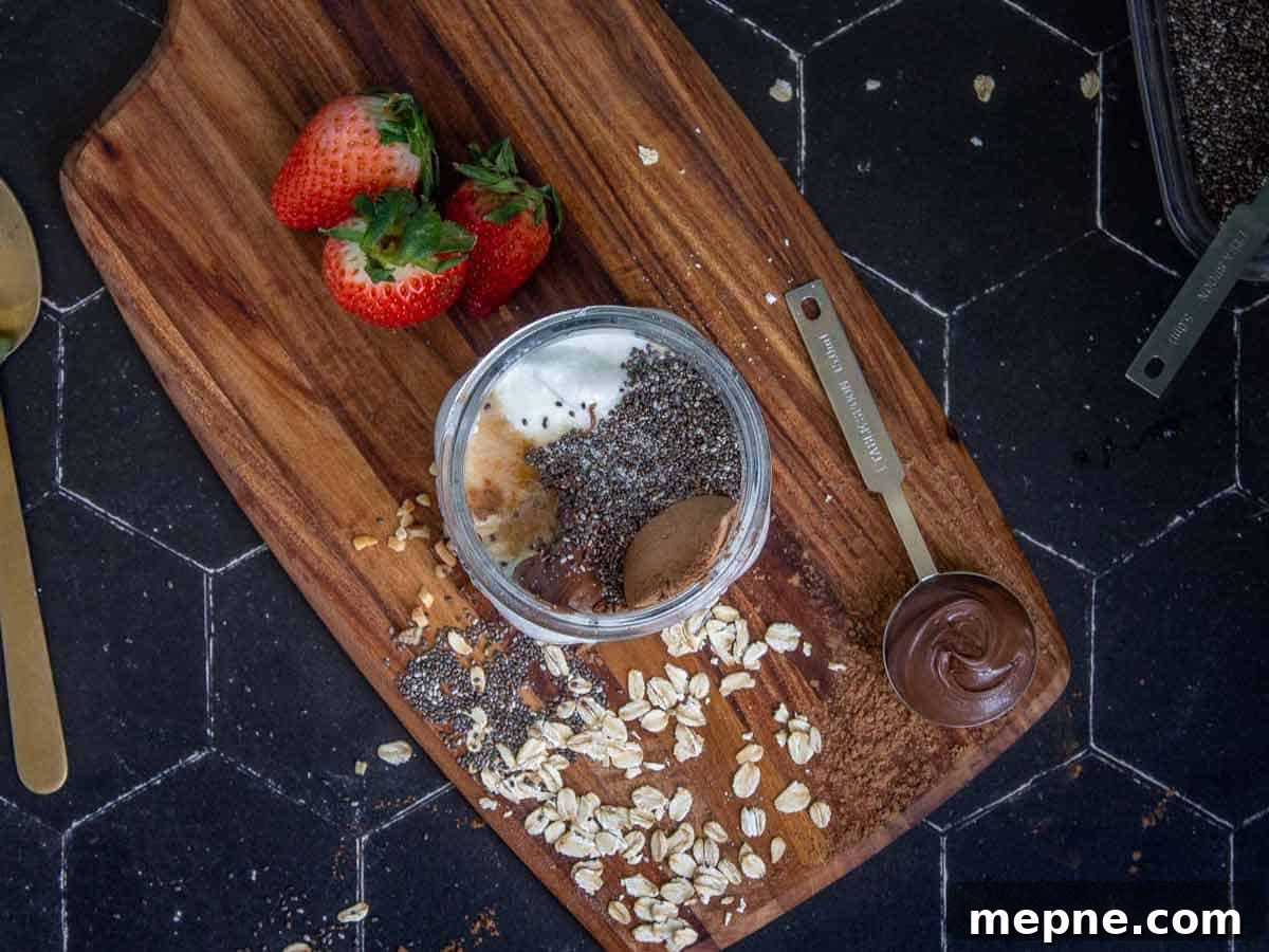 Old fashioned oats, milk, whole milk plain yogurt, maple syrup, Nutella, chia seeds, vanilla extract, cocoa powder, and salt are added to a mason jar.