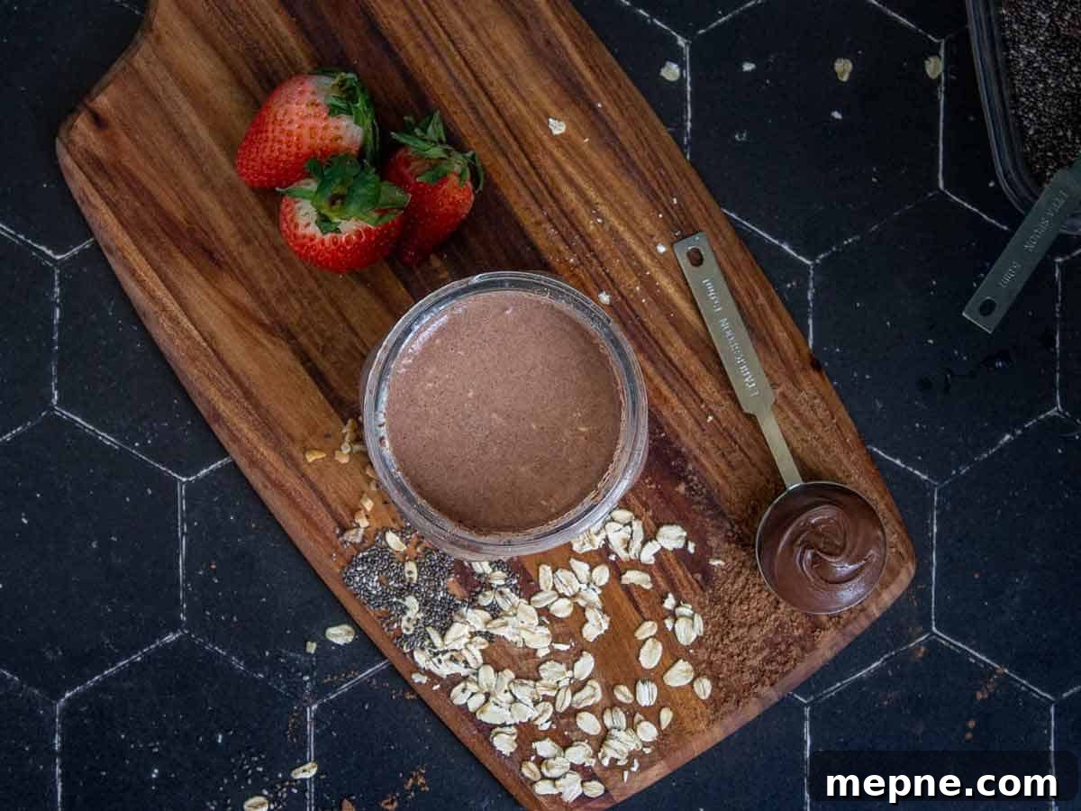 Nutella overnight oats ingredients are completely mixed together in a mason jar.
