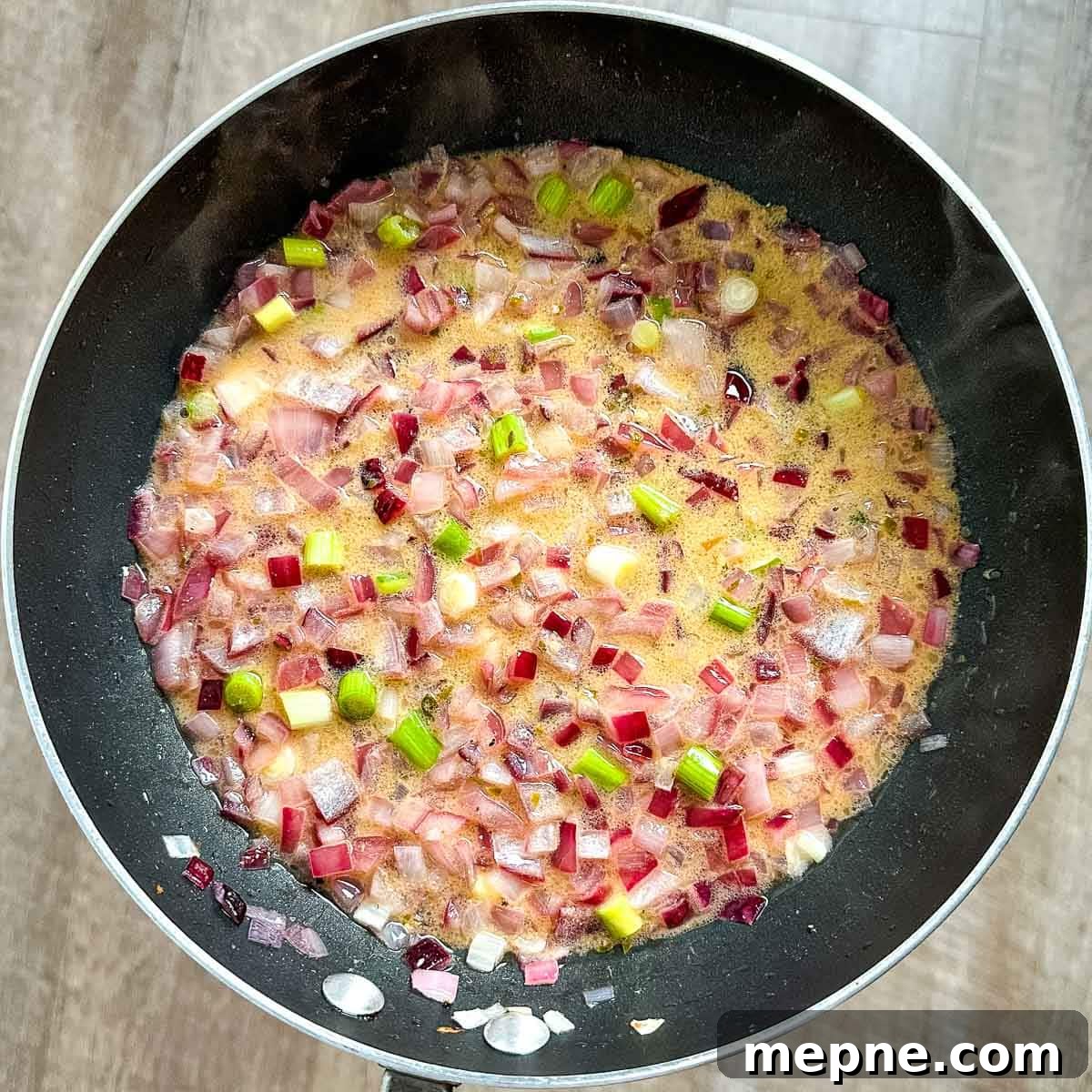 Authentic Bavarian Potato Salad with Bacon Recipe 13 adding vinegar and mustard to pan with cooked onions, bacon fat, and scallions.