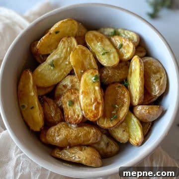 Air Fryer roasted fingerling potatoes dressed in olive oil, lemon juice, garlic, and thyme
