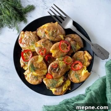 Smashed air fryer potatoes dressed in lemon, rosemary, chili vinaigrette