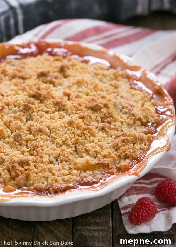 Peach Raspberry Crisp - A heavenly summer dessert that's easy and unforgettable!! Peach Raspberry Crisp in a white porcelain pie plate.