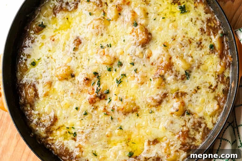 French Onion Gnocchi with Gruyere 3 french onion gnocchi in a skillet with melted gruyere and parmesan cheese