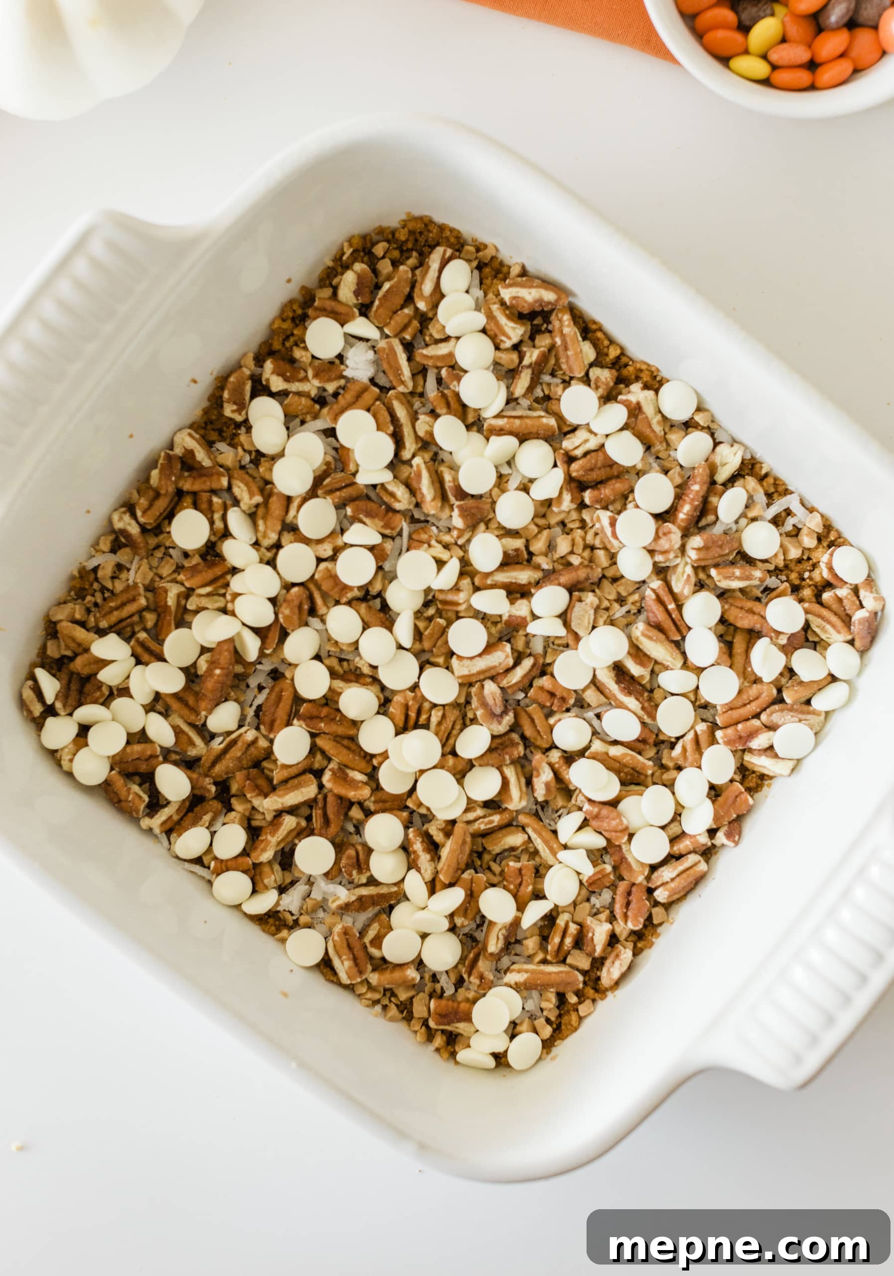 Pumpkin Magic Bars with Graham Cracker Crust 8 Adding pecans to Pumpkin Magic Bars