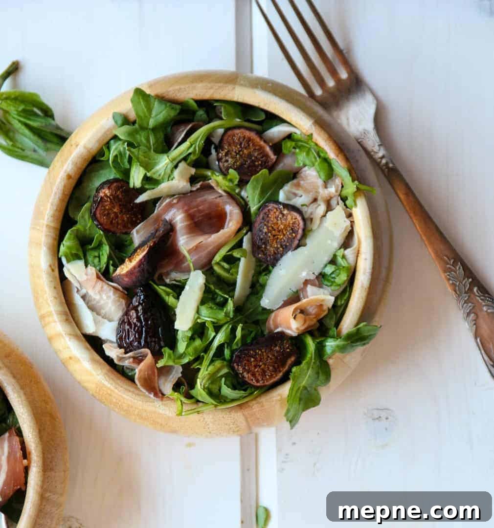 Fig, Prosciutto and Arugula Salad Recipe 7 A bowl of salad and a fork on a table