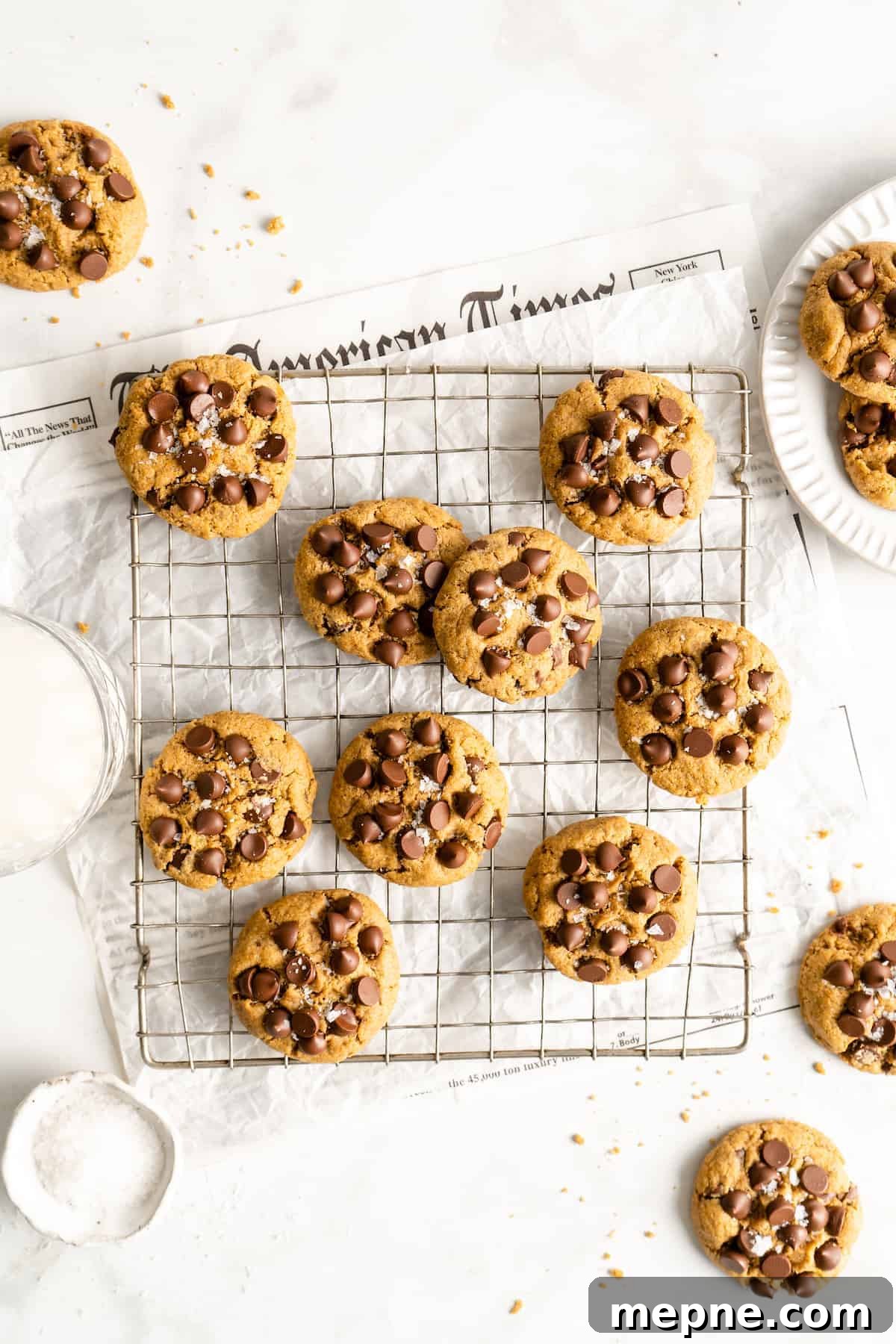 These vegan gluten-free chocolate chip cookies are an easy one-bowl recipe! Make soft, chewy, bakery-style cookies loaded with chocolate. Overhead view of assorted vegan gluten-free chocolate chip cookies in a wire rack.