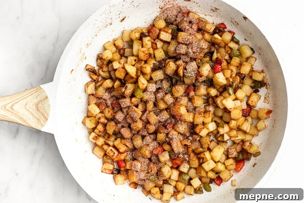 Southwestern Skillet Potatoes Recipe with Peppers and Onions 4 Potatoes browning in a skillet