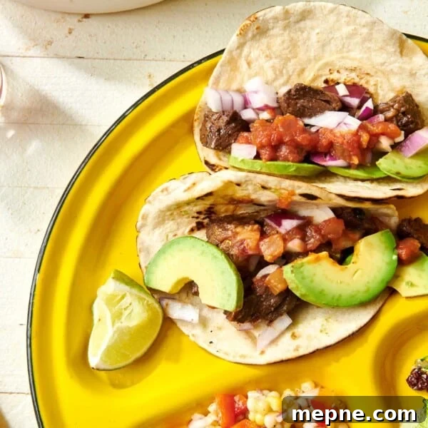 How to Get Perfect Crosshatch Grill Marks on Steak 6 Steak Street Tacos on yellow plate with avocado and other toppings.