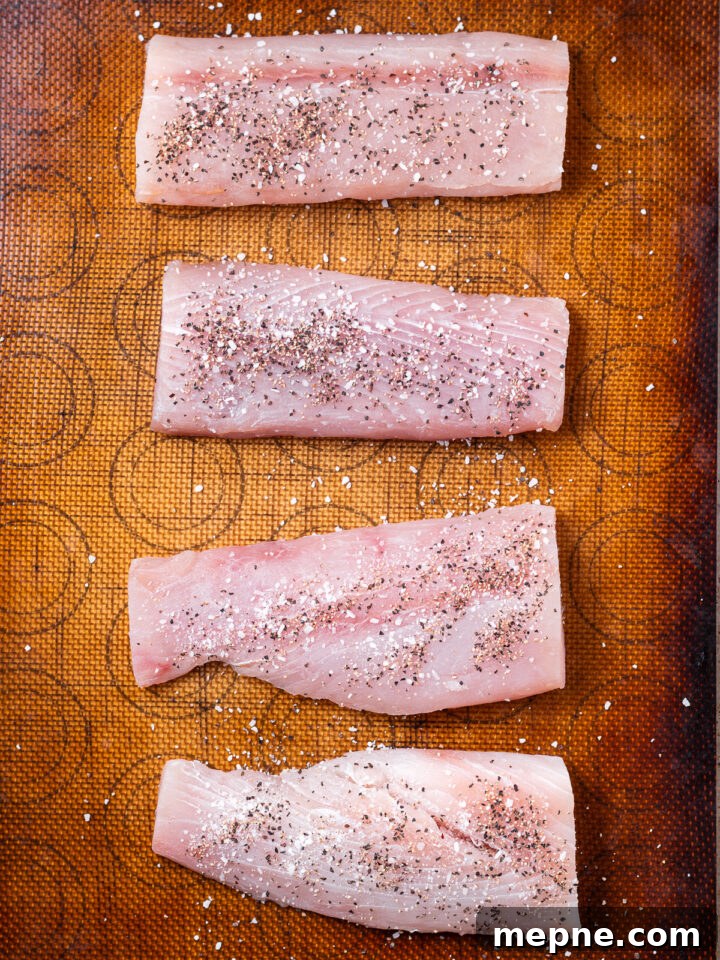 Broiled Mahi Mahi with Parmesan Butter Crust 5 Seasoned fish fillets on a lined baking sheet