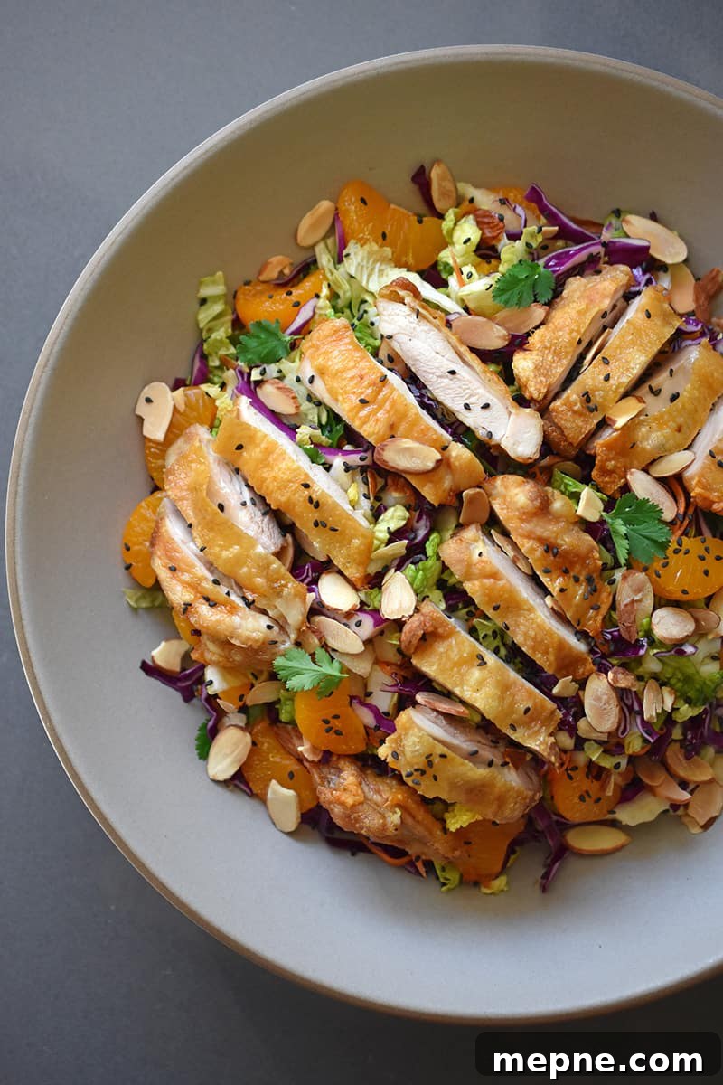 Whole30 Chinese Chicken Salad Gluten Free 2 An overhead shot of Whole30 and paleo Chinese Chicken Salad, a colorful blend of cabbage, carrots, mandarin oranges, herbs, and crispy Cracklin' Chicken.