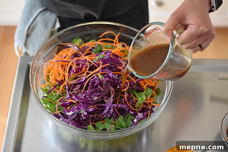 Whole30 Chinese Chicken Salad Gluten Free 8 Pouring the paleo salad dressing over the Whole30-friendly Chinese Chicken Salad.