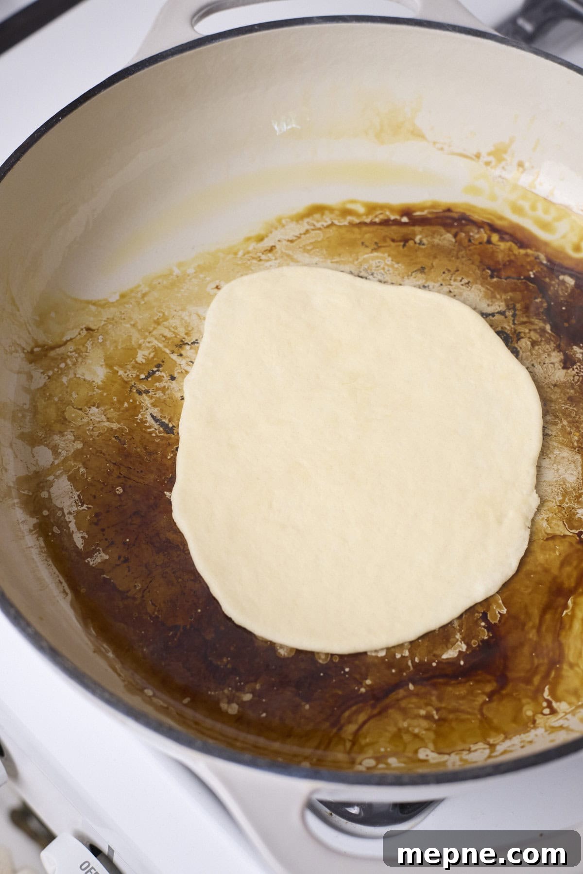 How to Make Sourdough Discard Tortillas 6 A tortilla cooking in a skillet.