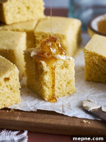 Sourdough Discard Cornbread topped with butter and honey.