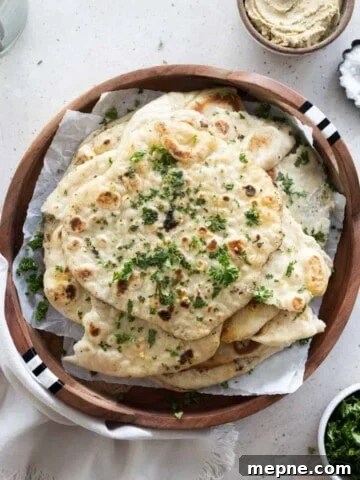 Sourdough discard naan on a wooden tray.