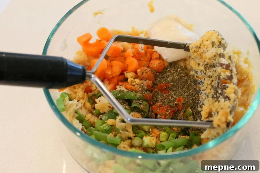 stuffed portobello mushrooms Chickpea stuffing ingredients for stuffed portobello mushrooms recipe being mixed in a bowl