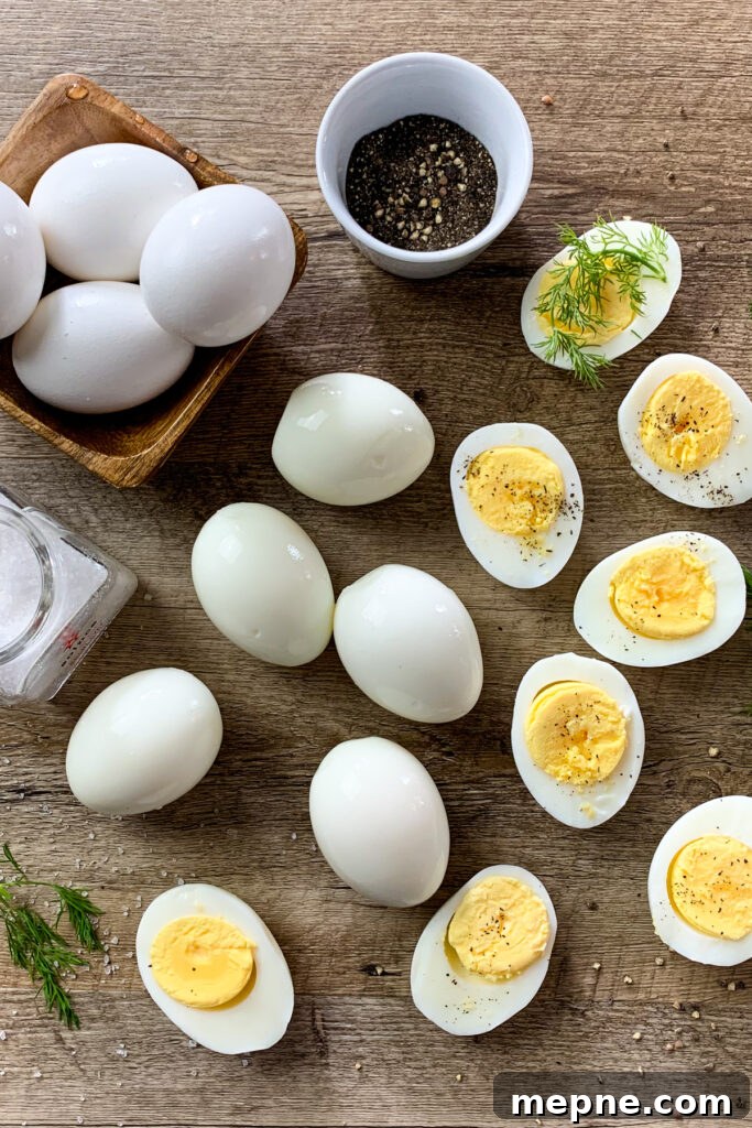 How to hard boil eggs so they are easy to peel. Boiled eggs cut in half on a cutting board.