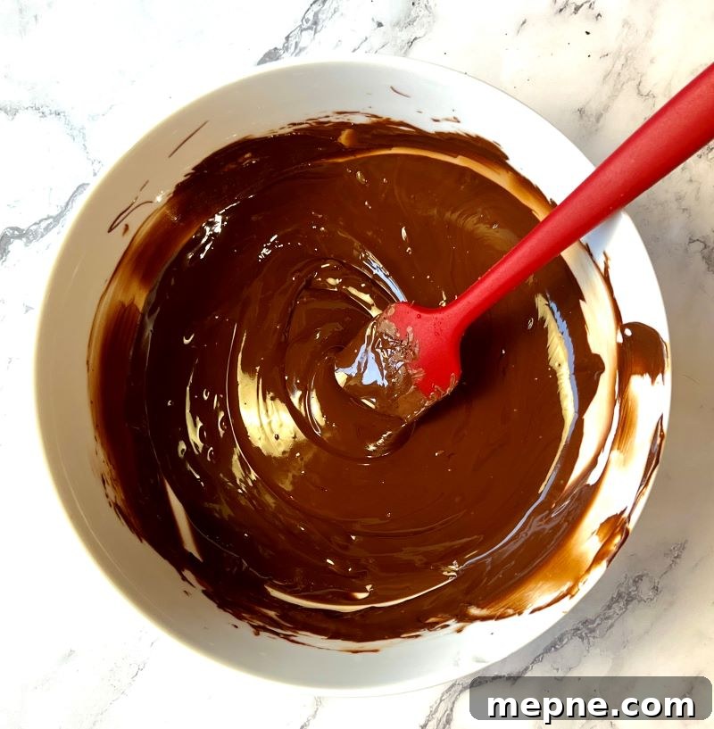 Cowboy Chocolate Christmas Bark Recipe 4 Melted chocolate chips in a microwave safe bowl.