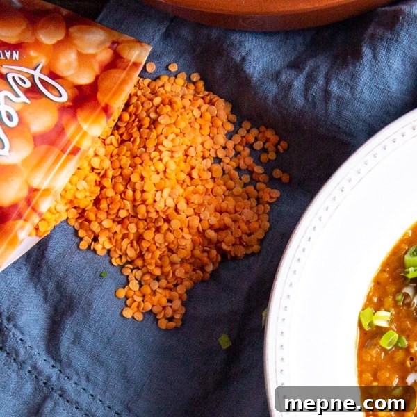 Flavorful Instant Pot Curried Lentil Soup Recipe 3 Close up shot of red lentils, also called orange lentils on a blue napkin.