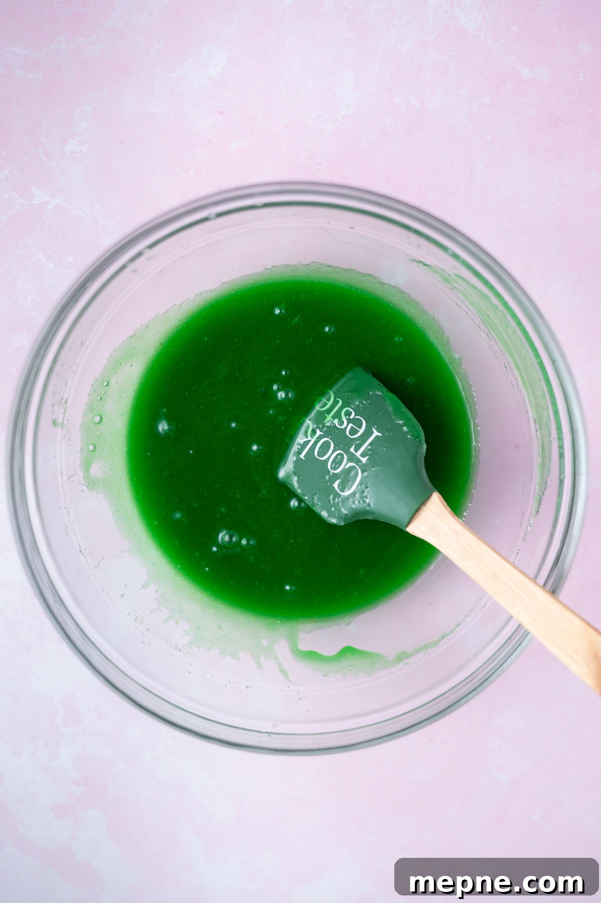 Soft Chewy Grinch Sugar Cookies for Christmas 6 egg, vanilla and green food coloring added to cookie dough in a bowl