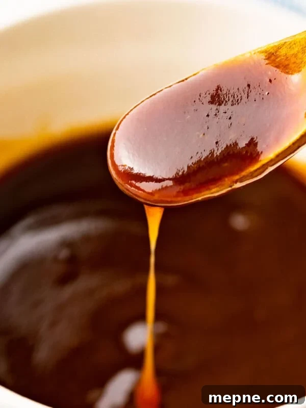 Tonkatsu sauce flowing off a spoon.
