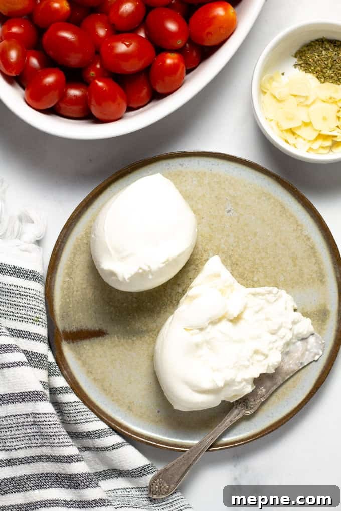 Close up shot of creamy burrata cheese on a gray plate on a white counter top