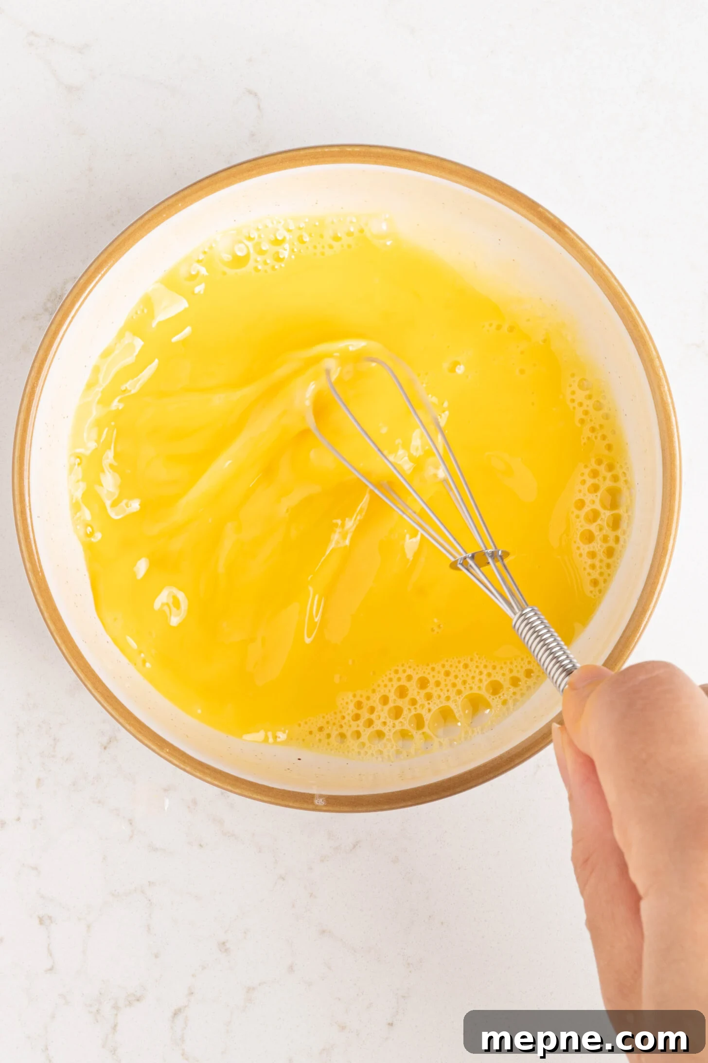 Authentic Puerto Rican Quesitos Recipe - Ready in 30 Minutes 5 Egg being beaten in a bowl.