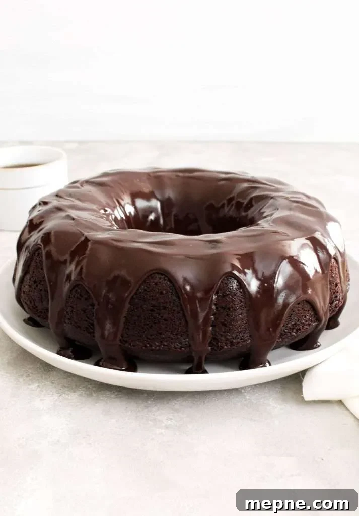 Rich Chocolate Bundt Cake with Silky Ganache Recipe 3 chocolate bundt cake topped with chocolate ganache quarter view