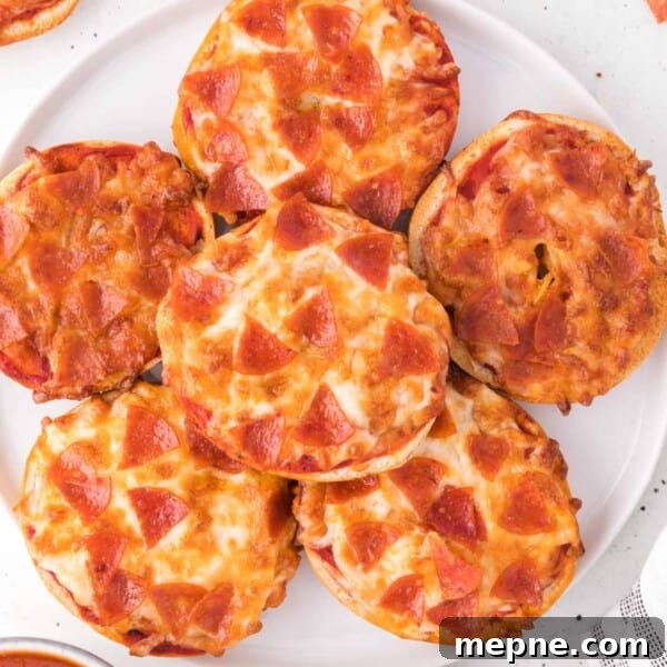 Air fryer bagel bites topped with pepperoni and cheese.