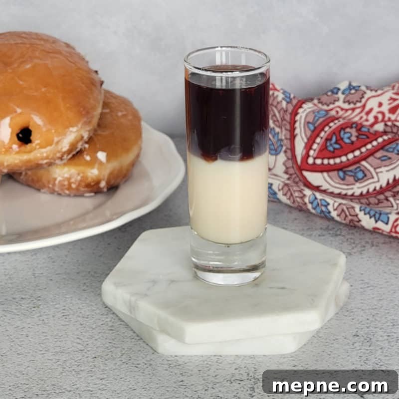 Chambord Cocktails: Raspberry Liqueur Recipes and Serving Tips 5 Layered Jelly Donut shot next to a jelly doughnut and napkin