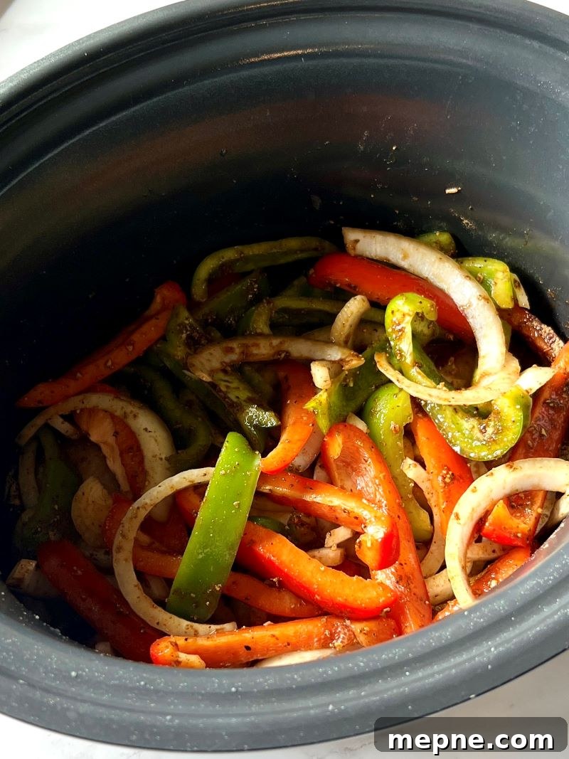 Slow Cooker Chicken Fajitas Recipe with Peppers and Onions 6 Peppers and onions in the slow cooker with chicken, fajita seasoning, and lime juice.
