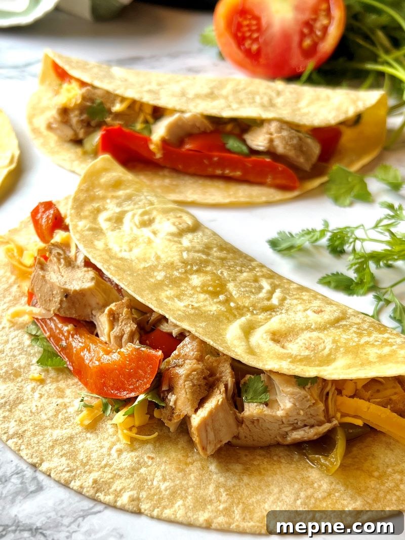 Slow Cooker Chicken Fajitas Recipe with Peppers and Onions 9 Tortillas layered with chicken, peppers, onions, and cheese.