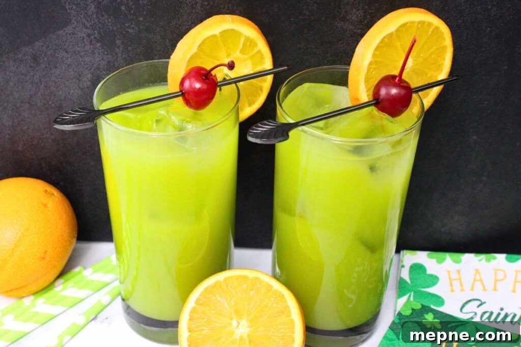 Drunken Leprechaun Irish Screwdriver Cocktail for St Patrick's Day 3 two glasses of drunken leprechaun cocktails with fresh orange slices against a black background