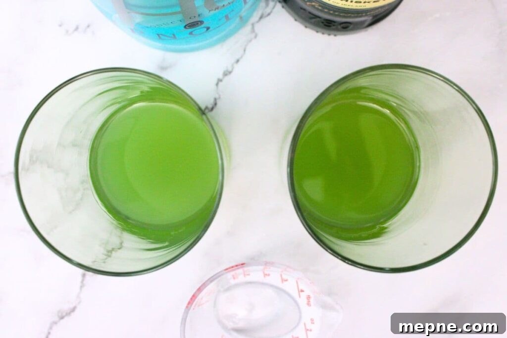 Drunken Leprechaun Irish Screwdriver Cocktail for St Patrick's Day 5 add irish whiskey and blue curacao to a glass