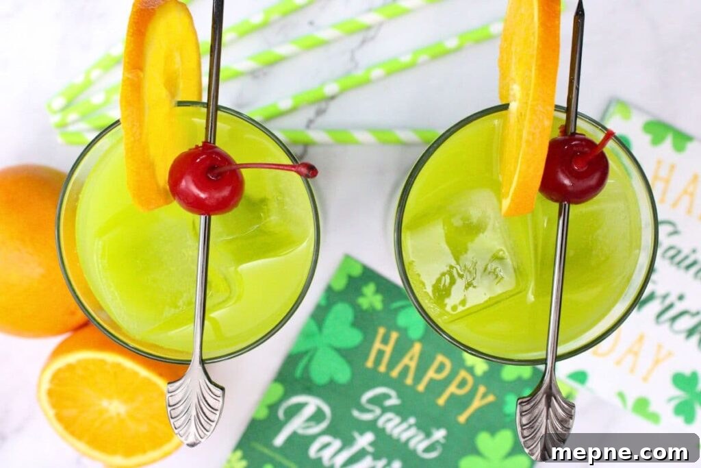 Drunken Leprechaun Irish Screwdriver Cocktail for St Patrick's Day 8 overhead view of two drunken leprechaun drinks with orange and cherries