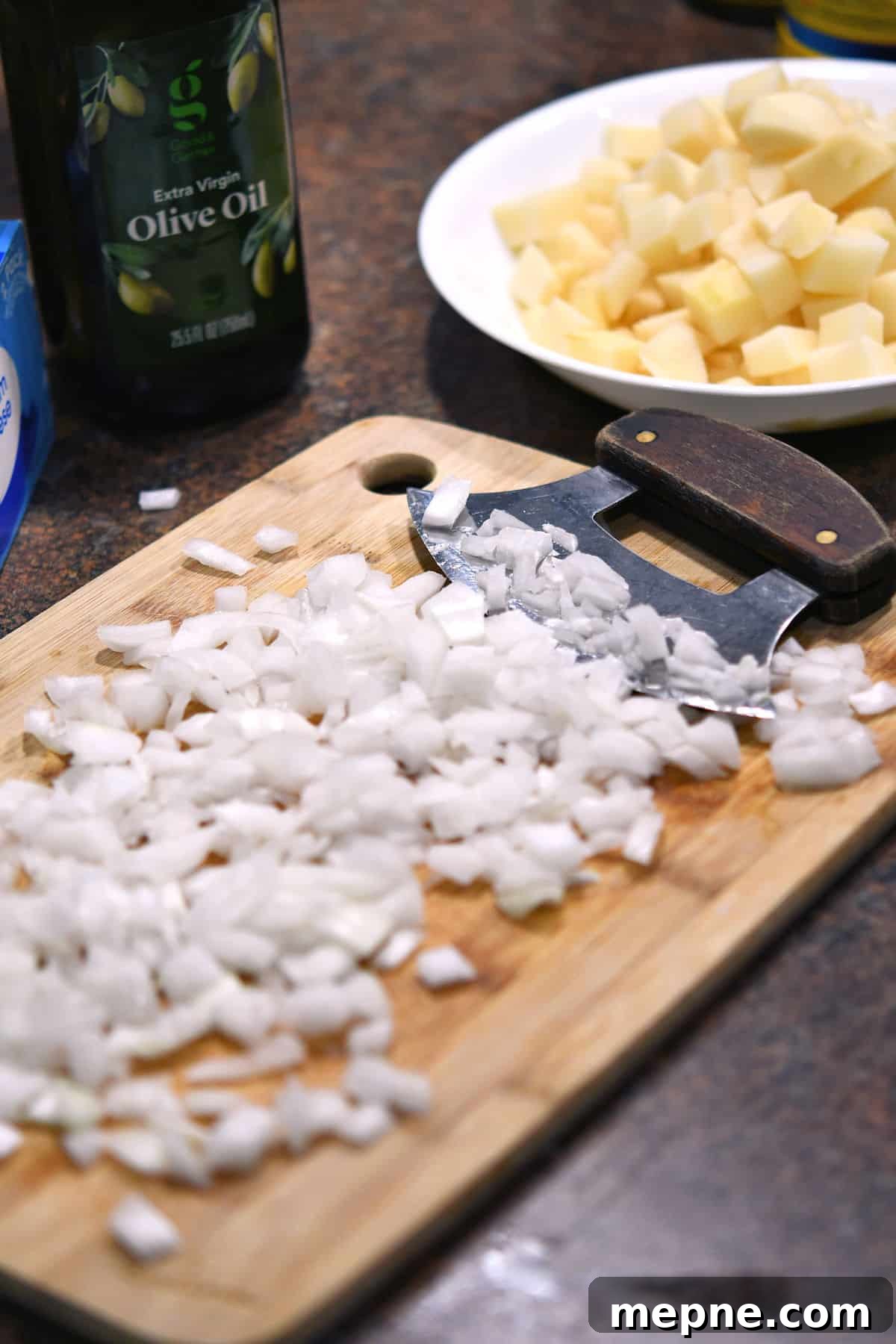Creamy Instant Pot Cheeseburger Soup Recipe 5 chopped onions and potatoes on a cutting board