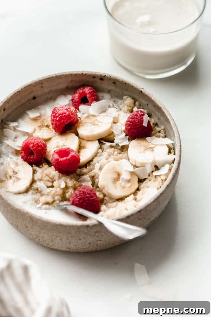 Protein-Packed Quinoa Breakfast Bowl with Avocado and Eggs 6 A bowl of quinoa topped with banana raspberries and coconut flakes