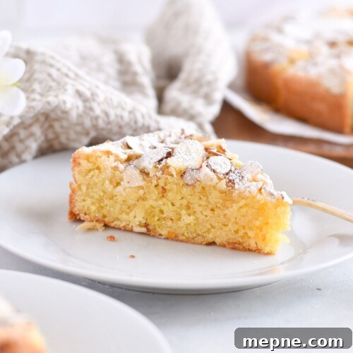 slice of almond cake on white plate.