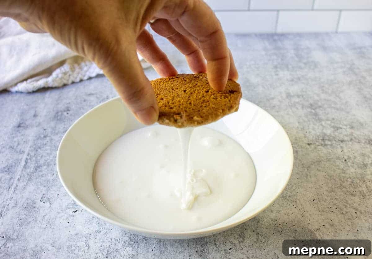 Old-Fashioned Iced Oatmeal Cookies Recipe 6 Icing dripping off the bottom of an oatmeal cookie.