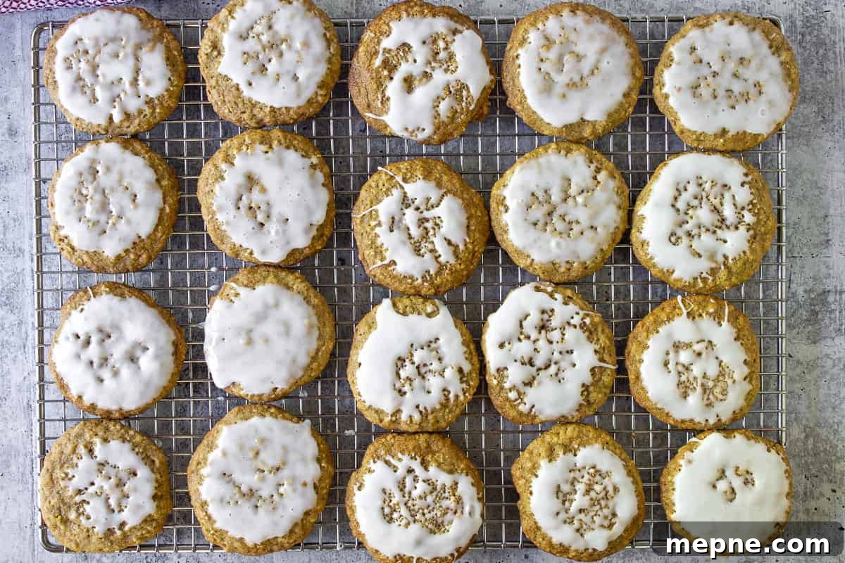 Old-Fashioned Iced Oatmeal Cookies Recipe 7 Rows of iced oatmeal cookies on a baking rack.