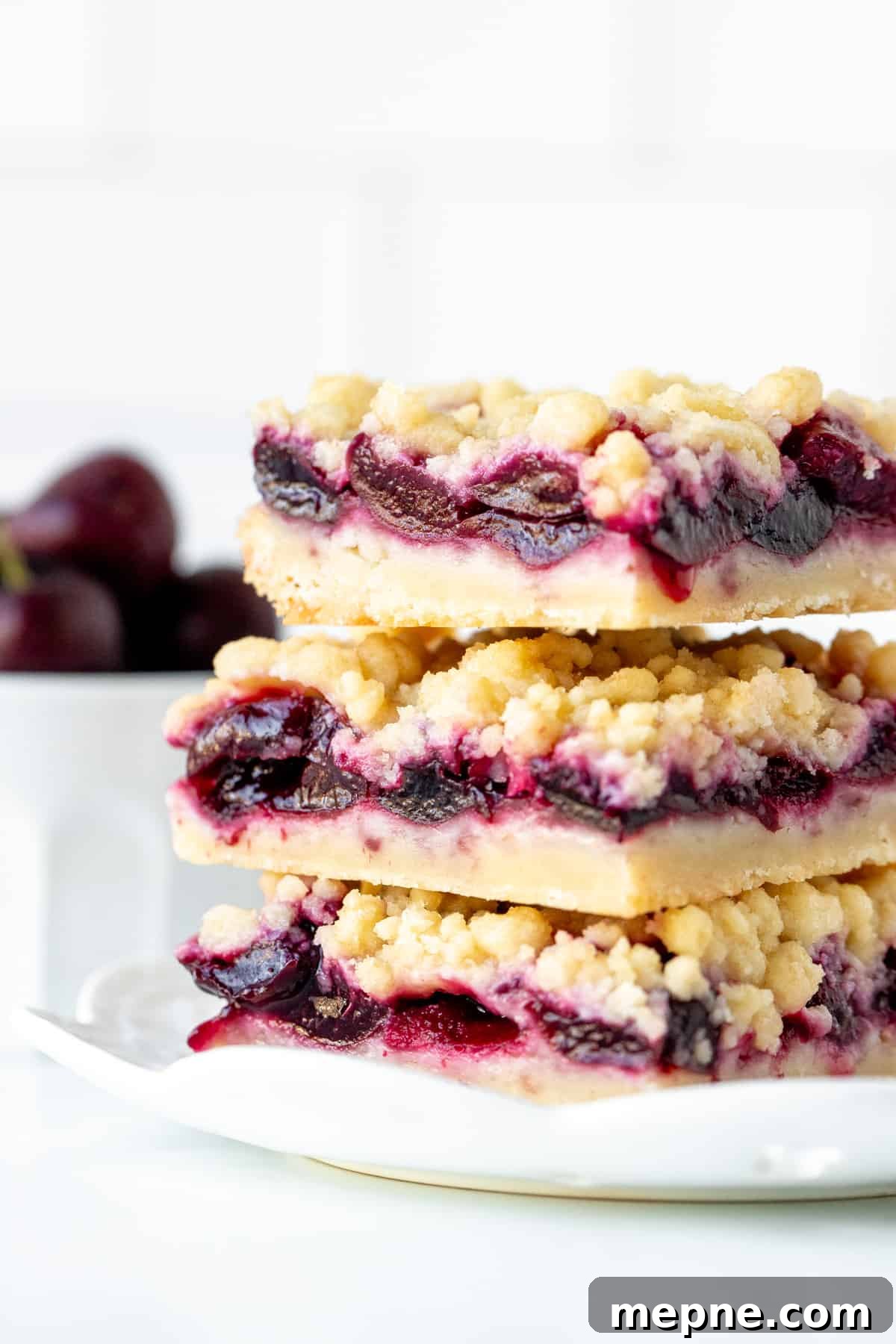 Homemade Cherry Crumb Bars Recipe 8 Three cherry shortbread bars with crumb topping, stacked one on top of eachother