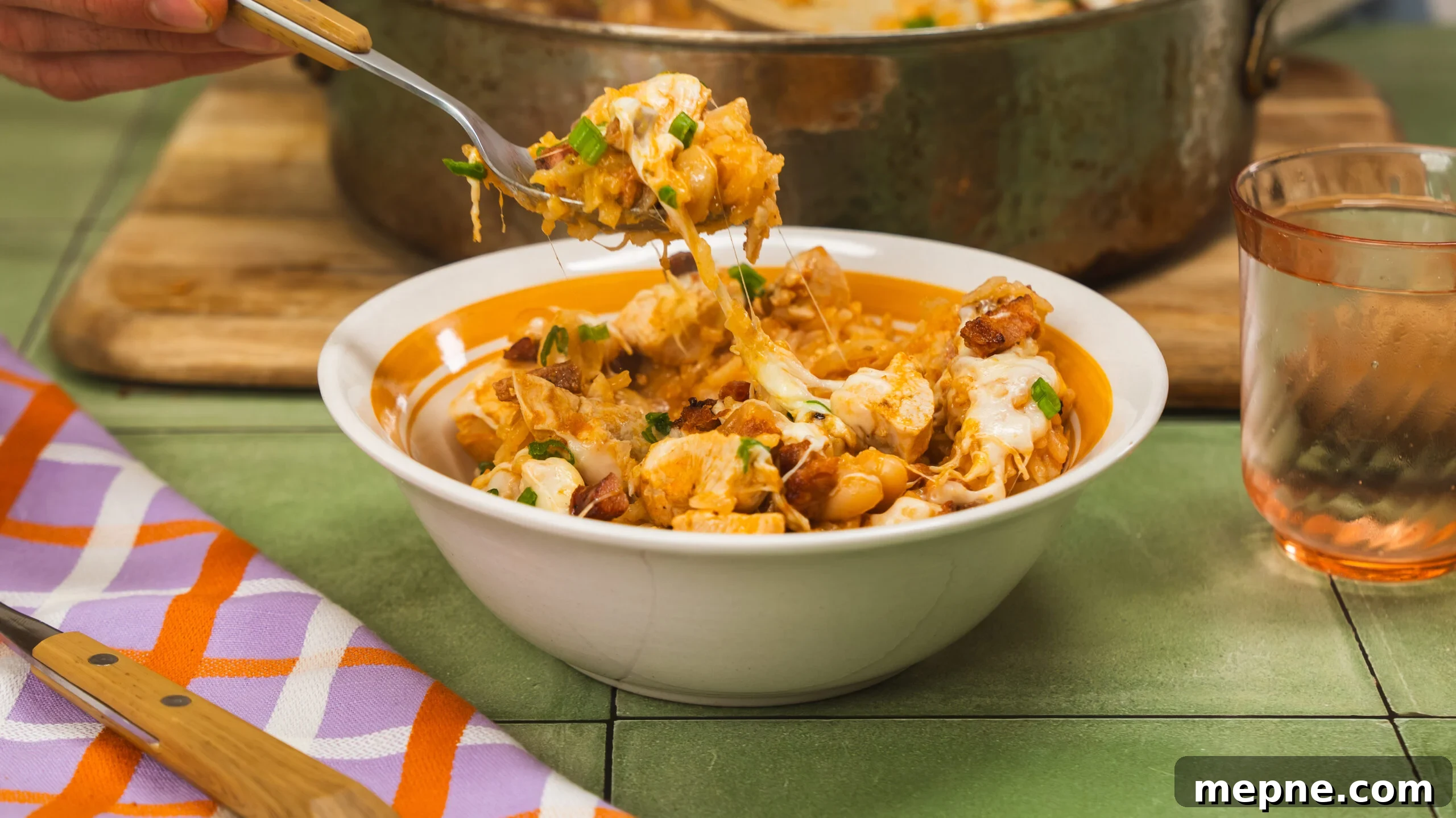 20-Minute Cheesy Chicken and Rice with Chorizo 3 Bowl of cheesy chicken and rice with chorizo and green onions