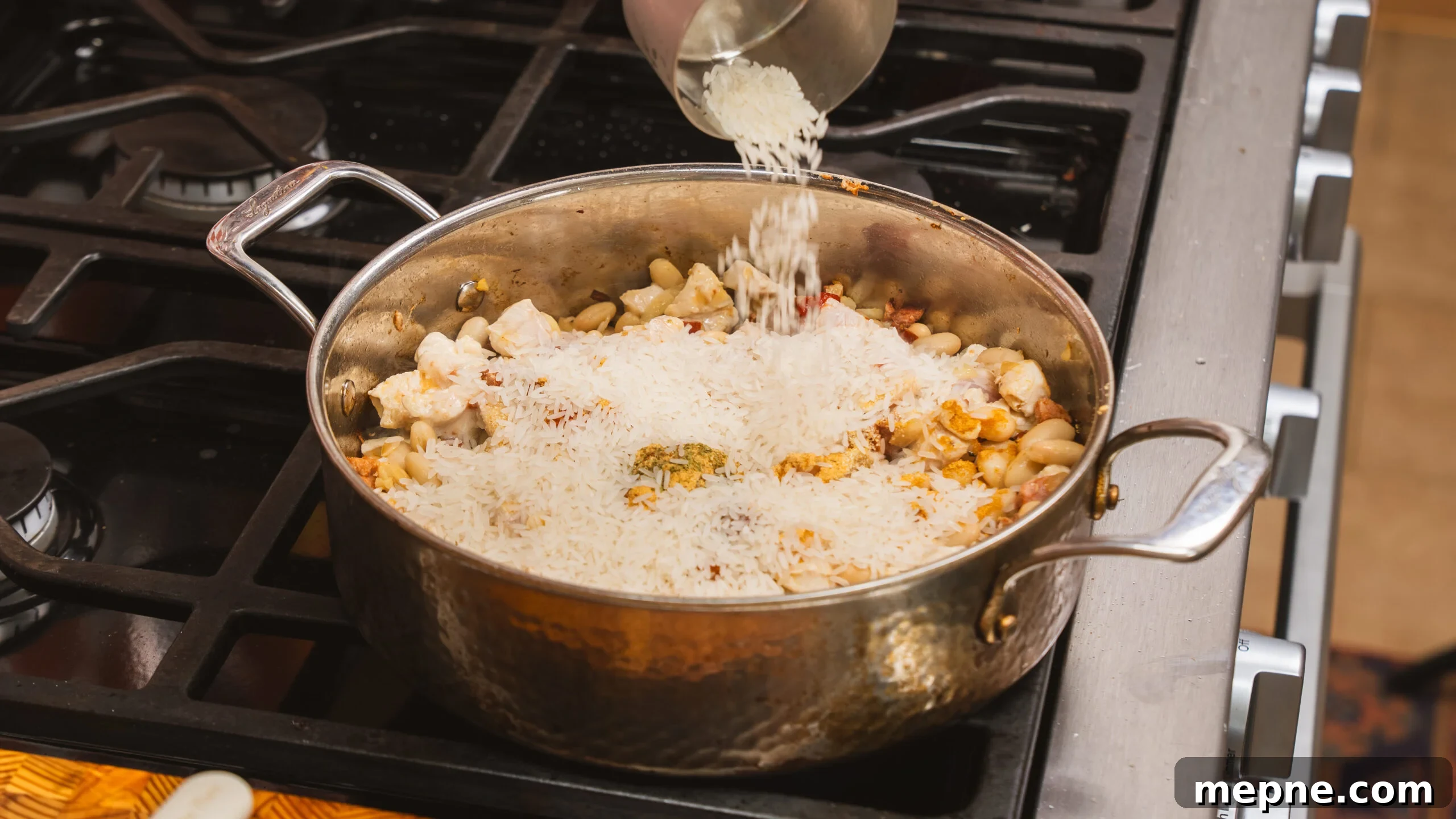 20-Minute Cheesy Chicken and Rice with Chorizo 4 Rice cooking in a skillet, developing flavor