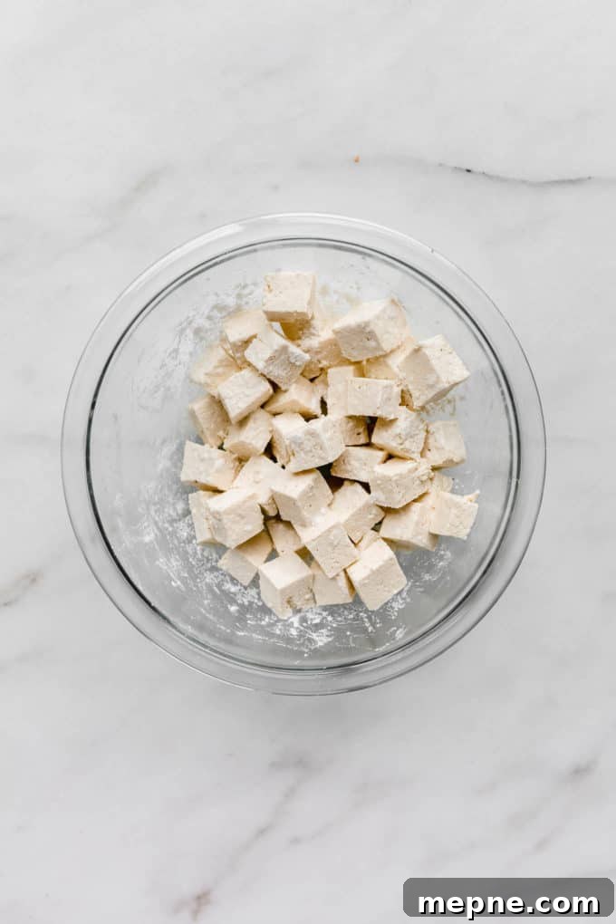 Crispy Baked Tofu with Teriyaki Glaze 3 cubed tofu in a clear mixing bowl
