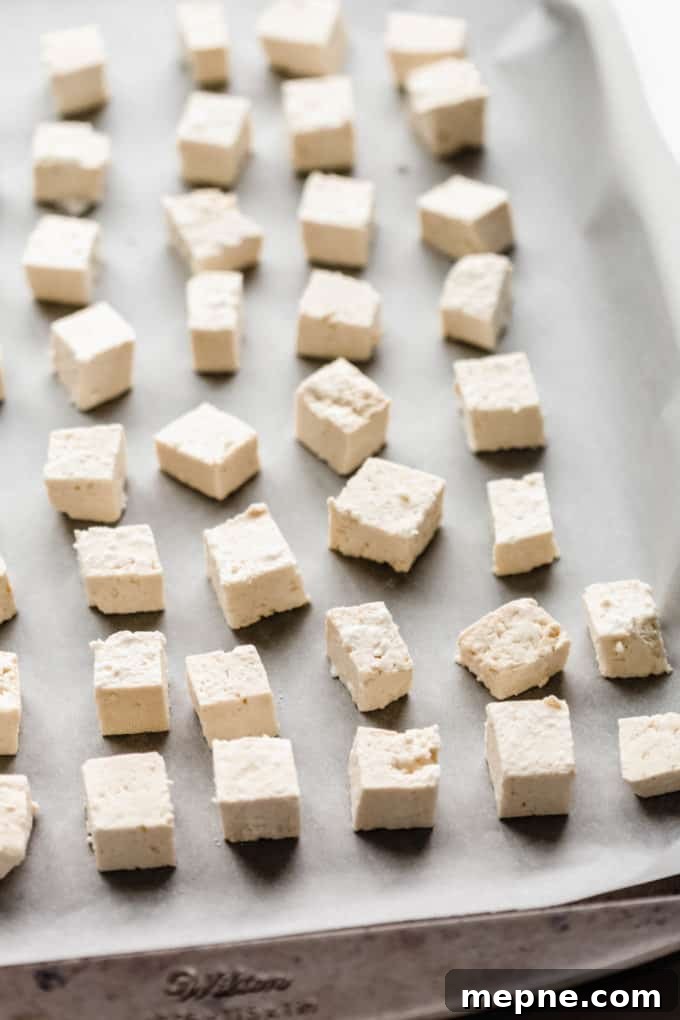 Crispy Baked Tofu with Teriyaki Glaze 4 cubes of tofu on a baking sheet