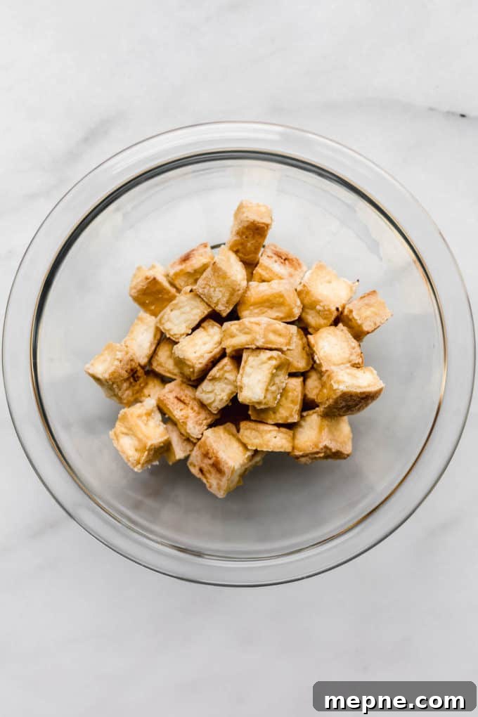Crispy Baked Tofu with Teriyaki Glaze 5 Baked crispy tofu in a clear bowl